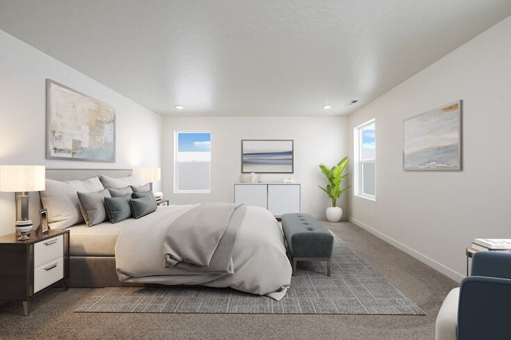 A large bedroom with a king-size bed, walkways on both sides, and a dresser at the foot